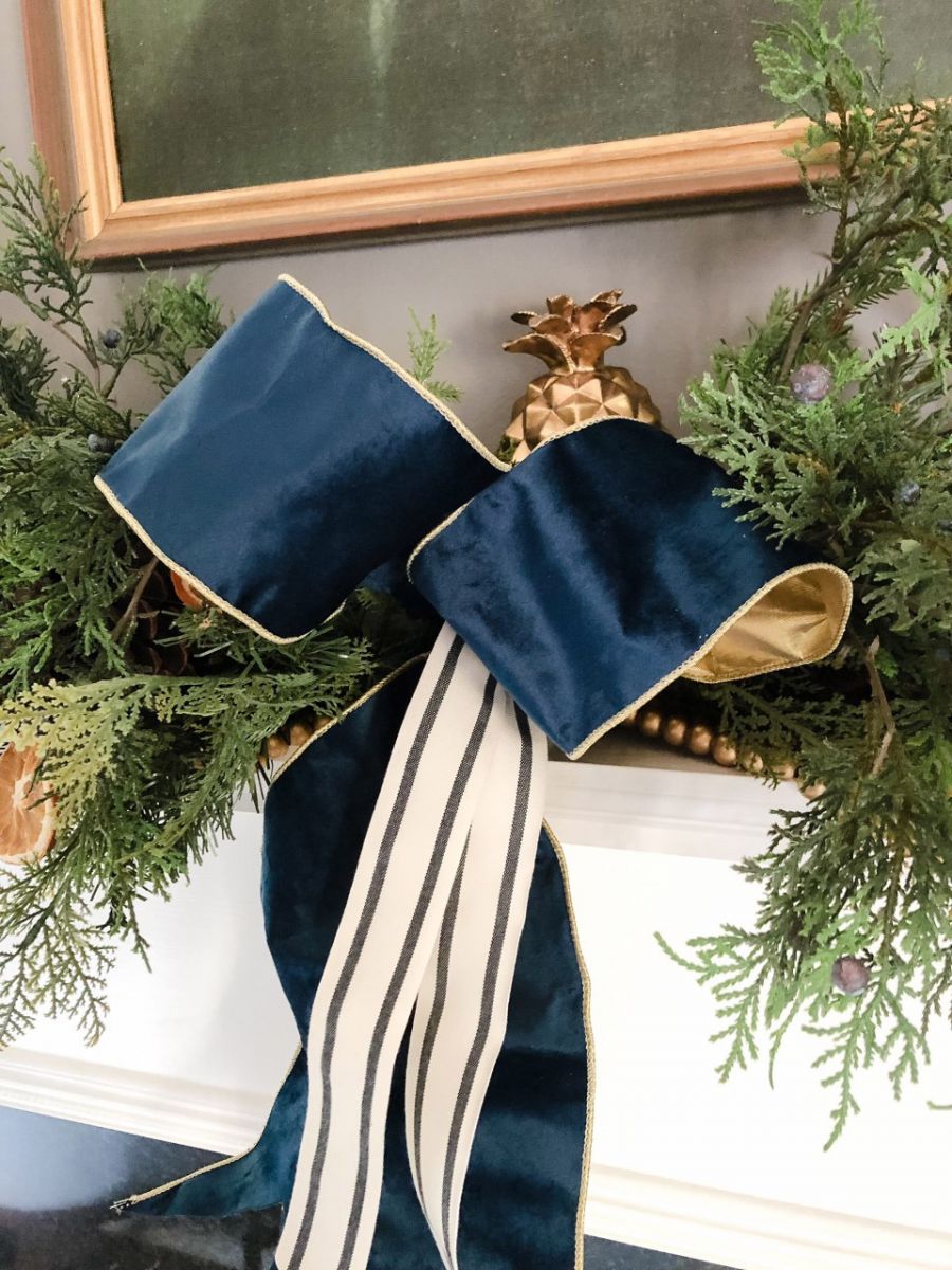 An intertwined ribbon with bow is added to the greenery.